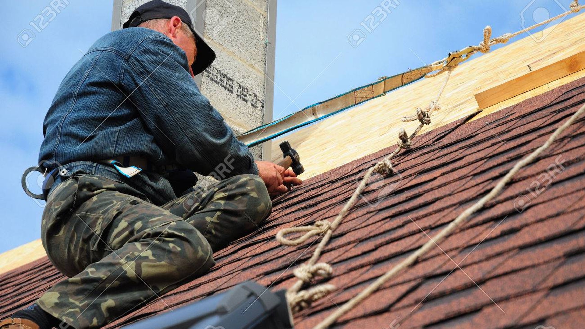 Professional roofer working on UK slate tile roof